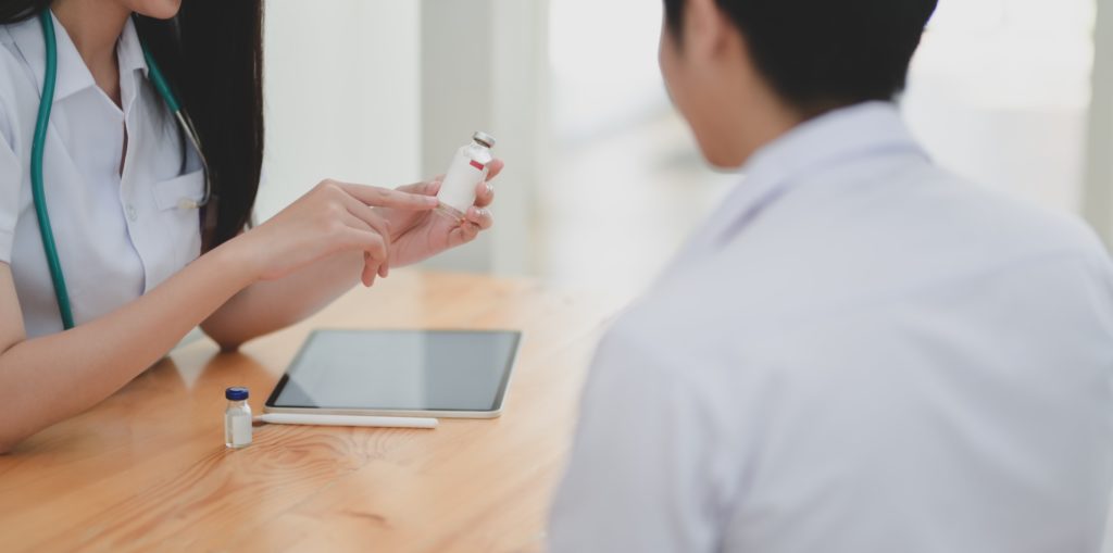 Photo of doctor explaining medication to patient